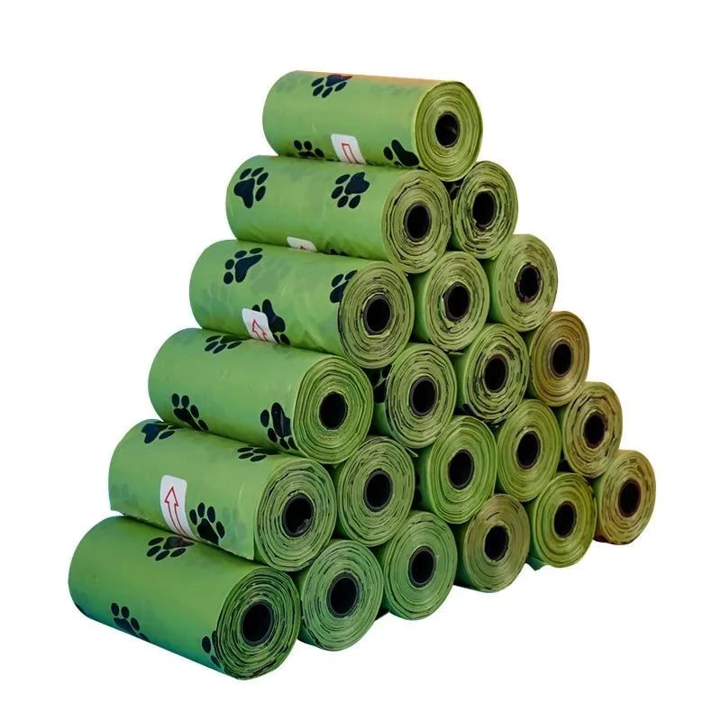 Load image into Gallery viewer, EcoScent Biodegradable Pet Waste Bags stacked with paw print design and dispenser included.

